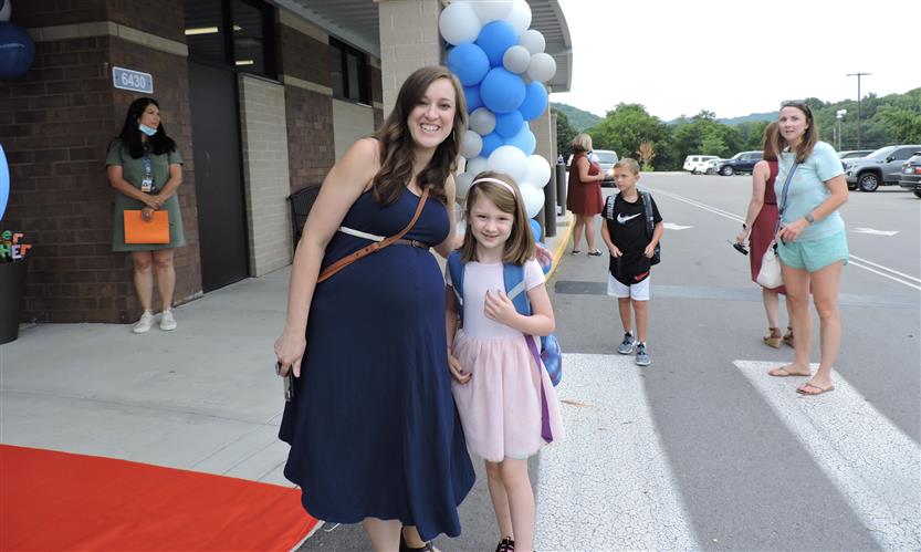 A mother and daughter smile